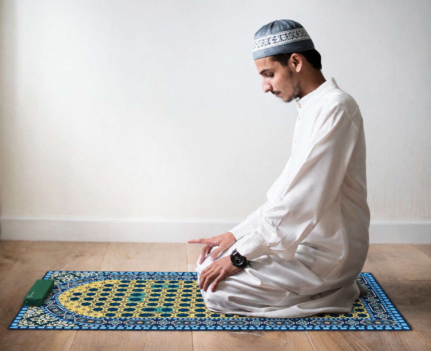 A Muslim worshipper using a NoorConnect prayer mat in a private setting