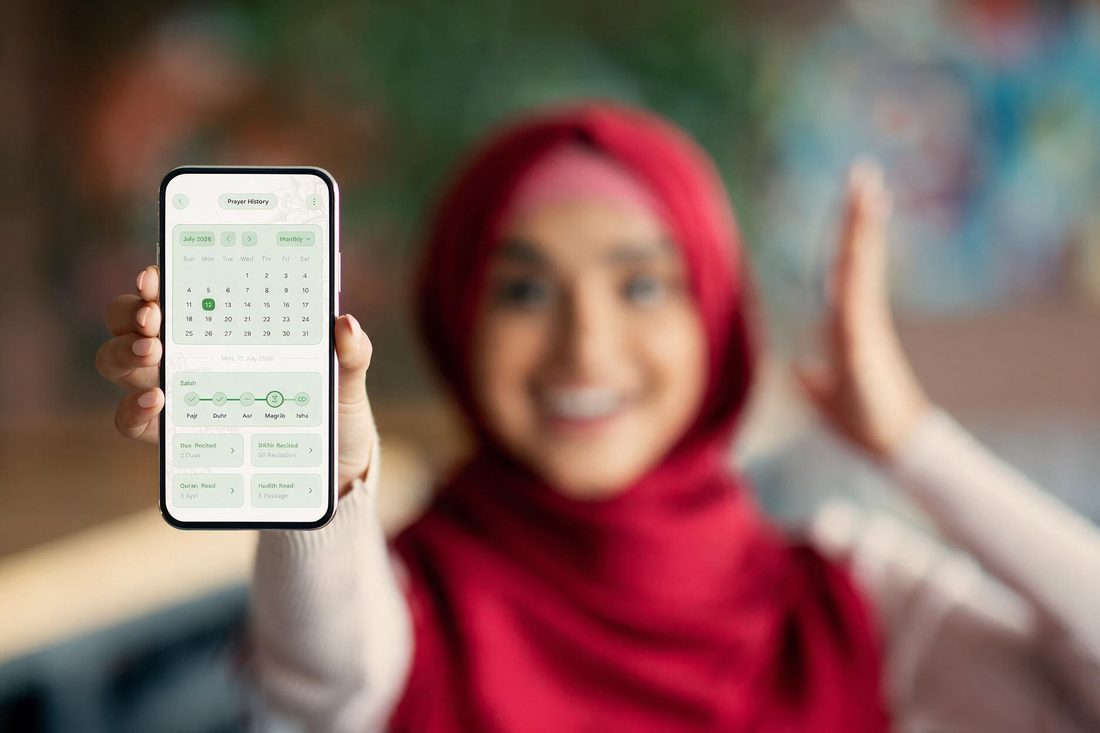 Woman holding a phone showing her monthly Salah, Dua, Quran and Hadith history
